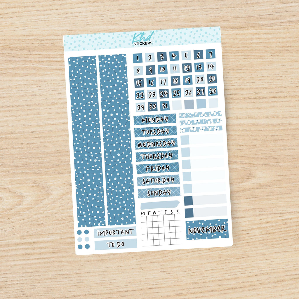 a blue and white planner sticker on a wooden surface